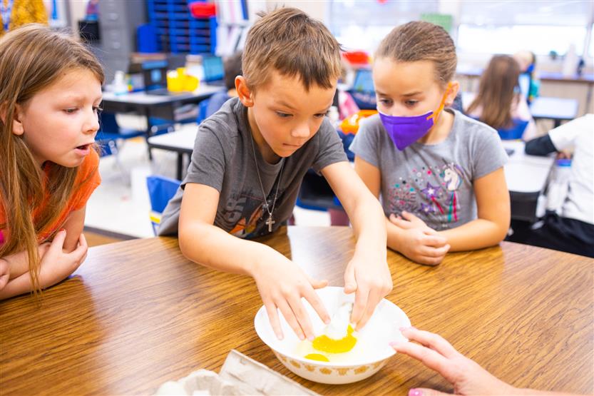A boy cracks an egg